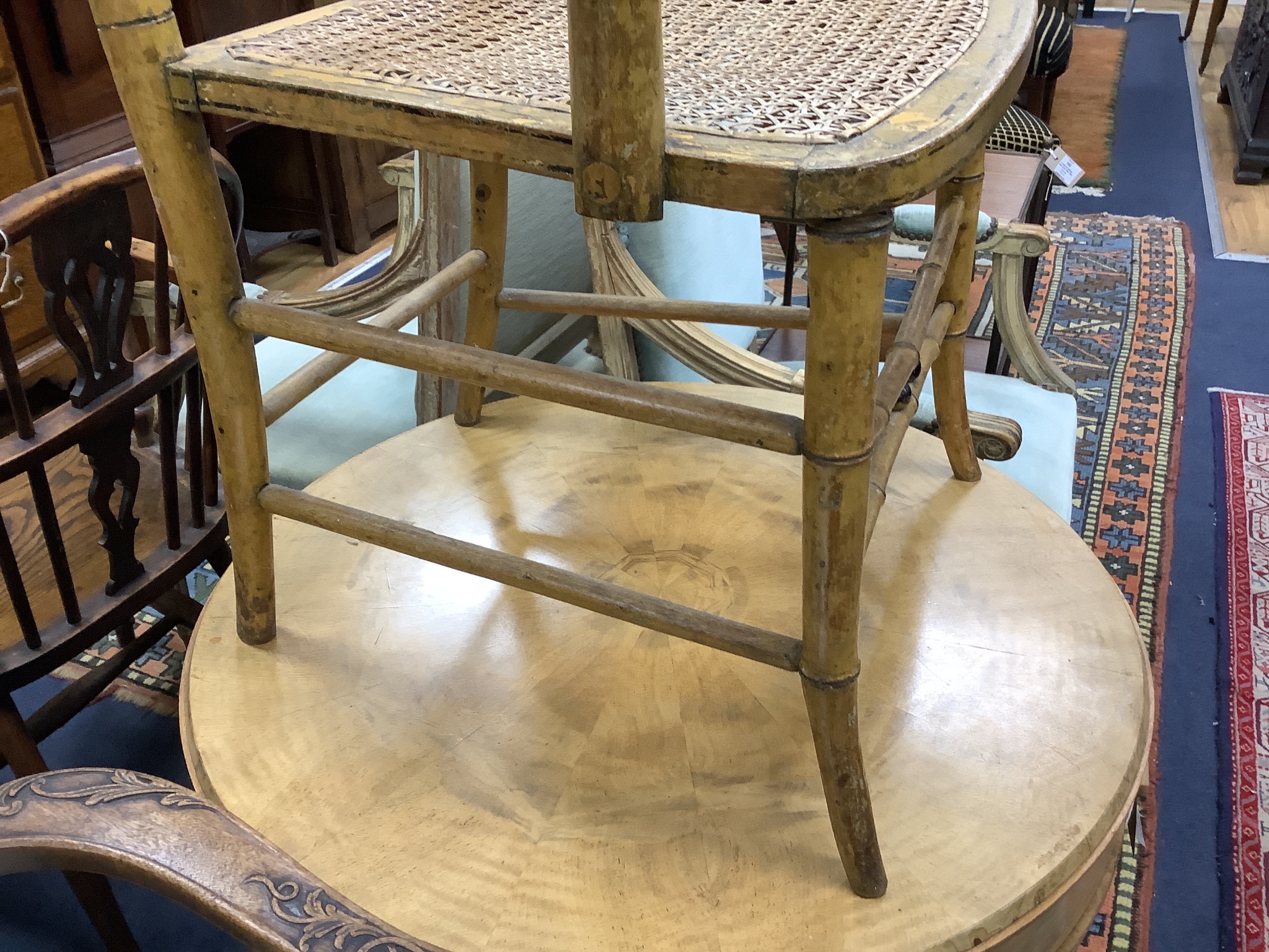 An early 19th century simulated bamboo elbow chair, cane seat